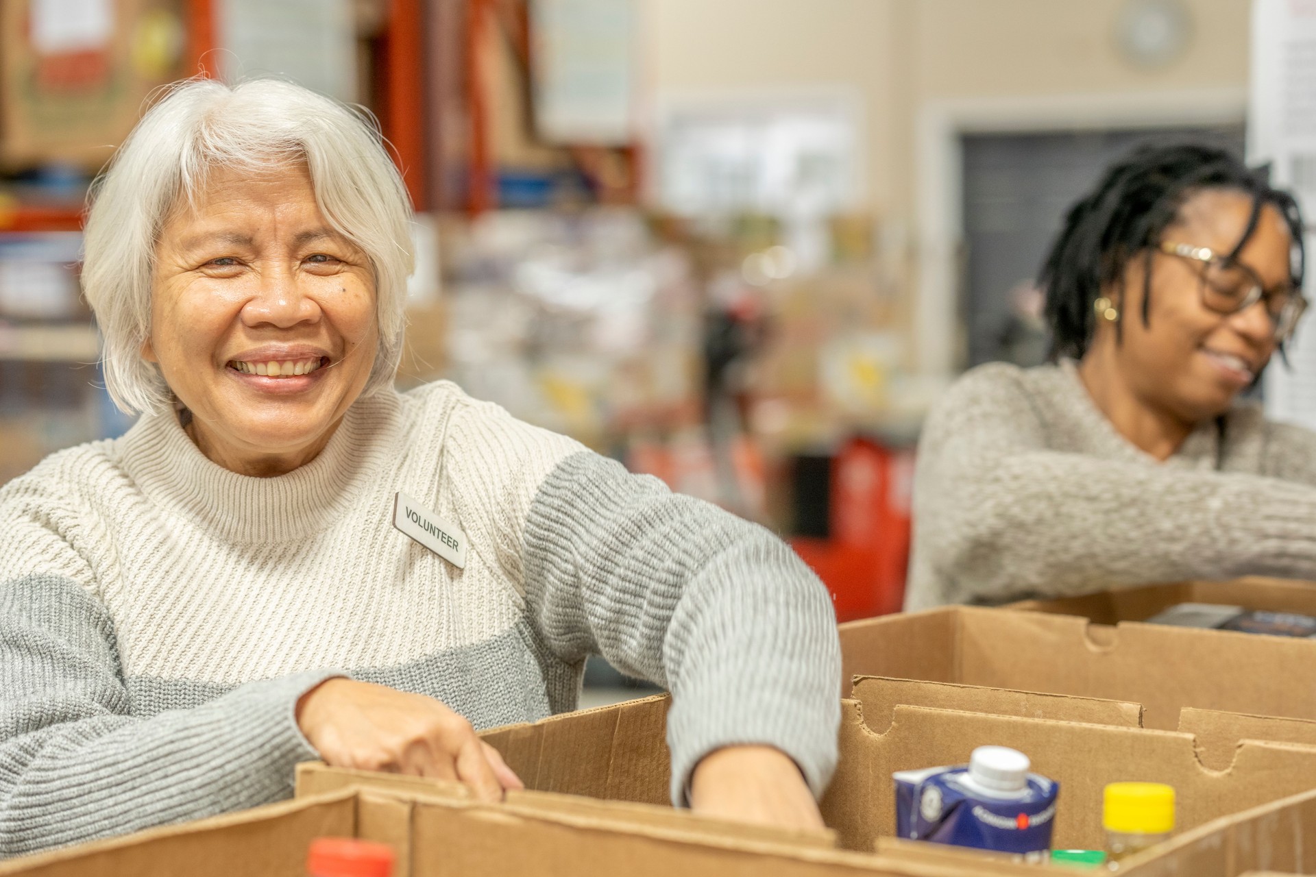 Seniors Packing Boxes at a Food Bank