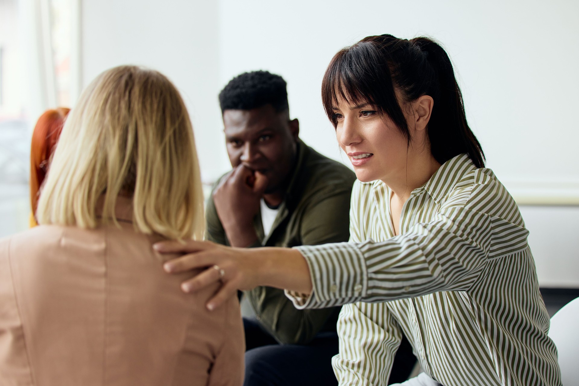 Support Group Discussion With Three Diverse People Engaged in Empathy and Understanding
