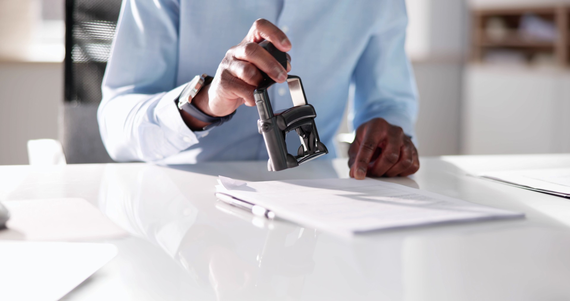 Mobile notary handing completed, stamped document to client in Concord, NC